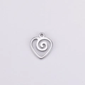 Macro shot of a polished silver heart pendant with spiral hollow pattern and hanging loop - Steel