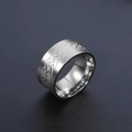 Macro view of silver stainless steel ring with intricate Celtic knot engraving detail - US 7 / Steel