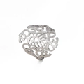 Macro shot of silver titanium steel ring featuring intricate hollowed-out pattern designs - Steel / US 7
