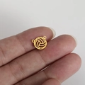 Gold stainless steel volleyball charm with hollow design held between fingers - Gold