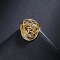 Elegant 18K gold plated hollow yoga Om symbol ring on a black leather texture display - US 7 / Gold