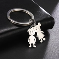 Polished stainless steel keychain with minimalist cartoon boy and girl pendants on leather - Boy And Girl / Silver