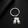 Minimalist stainless steel keychain with two silver boy pendants on dark background - Messy Hair Boys / Silver