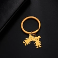 Polished golden stainless steel keychain with minimalist cartoon girl pendant charms - High Ponytail Girls / Gold