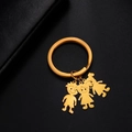 Golden stainless steel keychain with cute cartoon boy and two girls silhouette charms - Boy And Girls / Gold