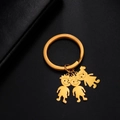Golden stainless steel keychain with three cartoon boy and girl pendants and mirror finish - Boys And Girl / Gold