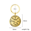 Macro detail of golden stainless steel magic talisman keychain with mystical engravings - Gold
