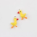 Detailed close-up of yellow duckling charms for jewelry making with silver rings - Yellow Duck