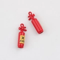 Close-up of red fire extinguisher charms with X-FIRE label for DIY jewelry making - Fire Extinguisher