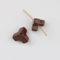 Macro shot of dark brown Y-shaped acrylic bead showing glossy finish and central hole - Brown