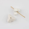 Detailed macro view showing a Y-shaped cream acrylic bead with a central hole for DIY jewelry - White