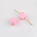 Close-up of pink acrylic cube beads with vertical holes for DIY jewelry making - Pink