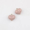 Detail view of heart-shaped pendants with lotus pink enamel and gold-toned metal rings - Large / Pink