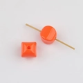 Macro view of vibrant orange acrylic waist beads with vertical holes for DIY jewelry - Orange