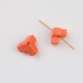 Close-up of bright orange geometric Y-shaped acrylic beads with smooth glossy finish - Orange