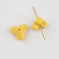 Detail of yellow Y-shaped acrylic bead with smooth finish and functional hole for DIY jewelry - Yellow