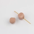 Detailed view of glossy nude pink acrylic beads with vertical holes for DIY jewelry - Khaki