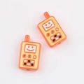 Close-up of orange acrylic walkie-talkie beads with smiley face for DIY jewelry - Orange