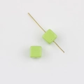 Detail of light green acrylic cube bead on golden pin for DIY jewelry making and crafts - Fruit Green
