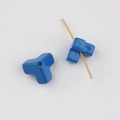 Macro view of blue acrylic T-shaped beads with glossy finish for DIY jewelry - Sapphire Blue