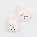 Close-up of pink acrylic walkie-talkie shaped beads with cute smiley face for DIY jewelry - White