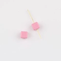 Detailed macro view of two pink square acrylic beads with glossy finish for DIY jewelry - Rose Pink