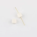Macro detail of creamy white square acrylic beads with center hole for DIY jewelry making - White