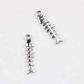 Macro shot of silver fish bone pendants for DIY jewelry with detailed metallic texture - Silver