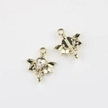 Detailed macro view of gold wing and heart pendant showing sparkling zircon inlay - Gold / White Zirconia