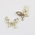 Detailed close-up of golden butterfly connector with clear zircons for DIY jewelry - Gold / White Zirconia
