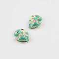 Macro detail of teal enamel rocking horse pendants with gold edges for DIY jewelry making - Gold Base Green