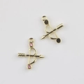 Detailed view of gold alloy bow and arrow charms with pink zircon inlay for DIY jewelry - Gold / Pink