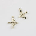 Detailed view of golden alloy bow pendants with white pearls and black dot accents for DIY - Gold Base Pearl
