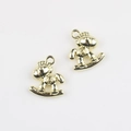 Detailed view of two gold alloy rocking horse charms for DIY jewelry making - Gold