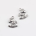 Close-up of silver-plated rocking horse charms with lucky coin detail for DIY jewelry making - White K/Silver