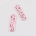 Close-up of pink rectangular alloy charms with carved Chinese luck text for DIY jewelry - Pink
