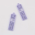 Close-up of two purple rectangular charms with hollowed-out Chinese luck characters - Purple