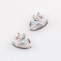 Close-up of pink enamel rocking horse charms with blue saddle and silver heart details - Silver Pink