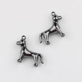 Macro view of twin puppy-shaped pendants in gunmetal mirror polish with secure top loops - Gunmetal