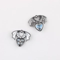 Detail of gothic wing heart pendants with white enamel and blue glitter star patterns - Gun Black Base White