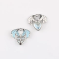 Detail of wing heart charms with blue enamel, cross inlay and silver star textures - Silver Base Blue
