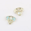 Close-up of DIY heart wing pendants with blue enamel, gold plating and zircon inlay - Gold Base Blue