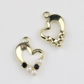 Macro detail of gold heart pendants with pearl and zircon inlay for DIY jewelry - Gold Base Black Rhinestone