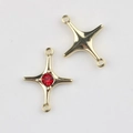 Macro shot of gold star charms with red zircon inlay and double connector loops for DIY jewelry - Gold Red Zirconia