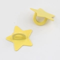 Macro view of two yellow star-shaped metal alloy hooks for DIY jewelry and phone cases - Yellow