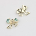 Close-up of bow-shaped jewelry pendant with blue gradient enamel and pearl details - Gold Base Blue