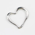 Macro detail of irregular hollow heart pendant with silver polished mirror finish - Silver