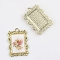 Detail of vintage gold alloy pendants featuring angel painting with baroque wavy edges - Gold Base Flower Angel