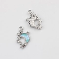 Close-up of crescent moon pendant charms with blue gradient enamel and small rhinestones - Silver Base Blue