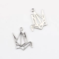 Macro detail of silver geometric origami paper crane charms for DIY jewelry making - Silver